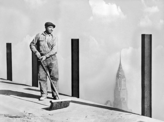 "A workman sweeping the highest sidewalk in the world, the 81st story of the Empire State Building. This photo was made 1,248 feet above street level. 1931."